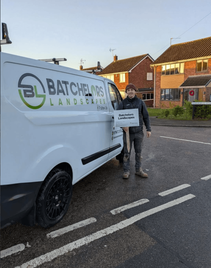 Lewis Batchelor, owner of Batchelors Landscapes, in front of his work van